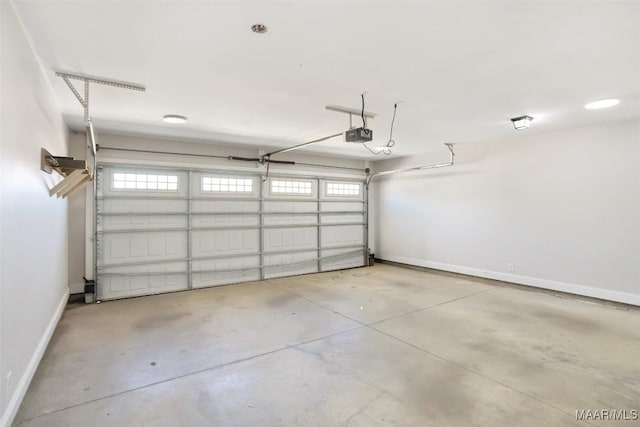 garage with a garage door opener and baseboards