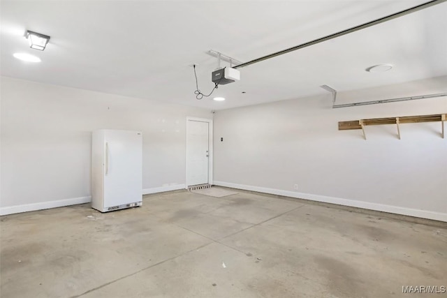 garage with a garage door opener, freestanding refrigerator, and baseboards