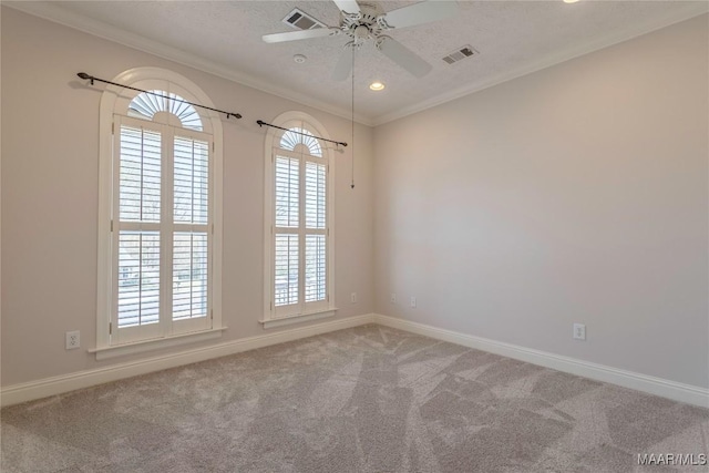 unfurnished room featuring ornamental molding, carpet flooring, and visible vents