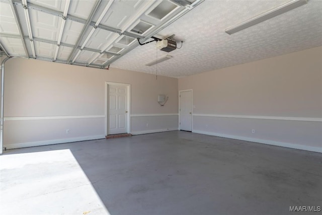 garage with a garage door opener and baseboards