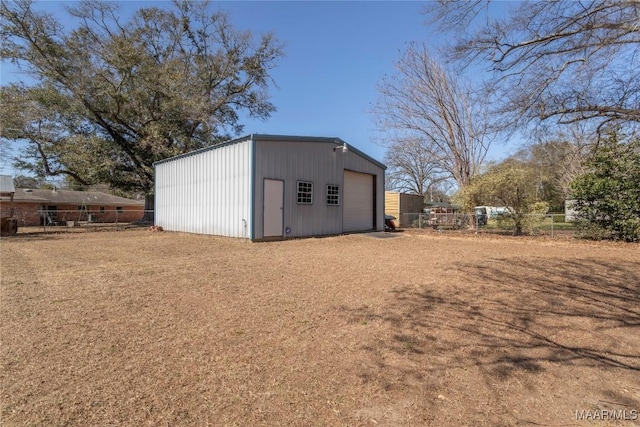 view of outbuilding featuring an outdoor structure and fence