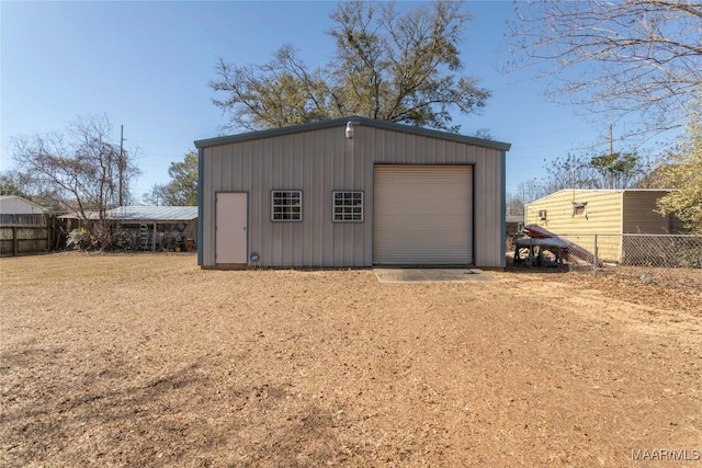 detached garage with driveway and fence