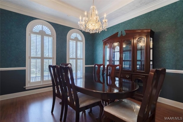 dining room with wallpapered walls, baseboards, wood finished floors, an inviting chandelier, and crown molding