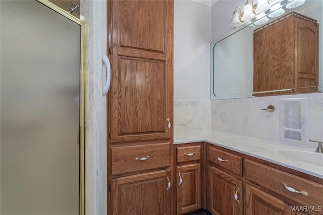 bathroom with a shower stall and vanity