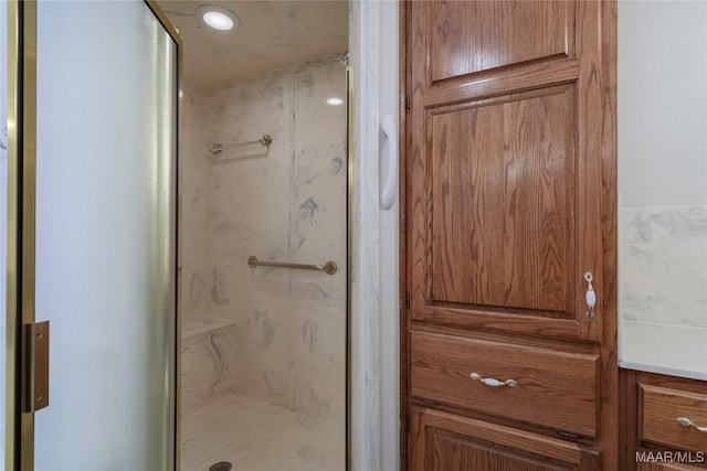 bathroom with a marble finish shower