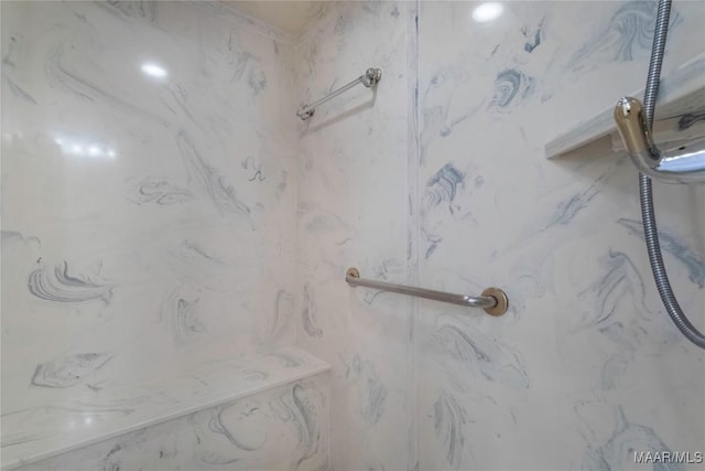 details featuring a marble finish shower