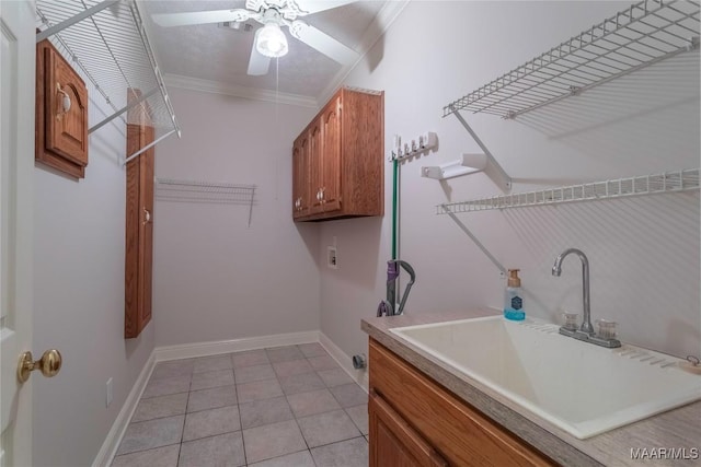 laundry area featuring crown molding, light tile patterned floors, hookup for a washing machine, cabinet space, and a sink