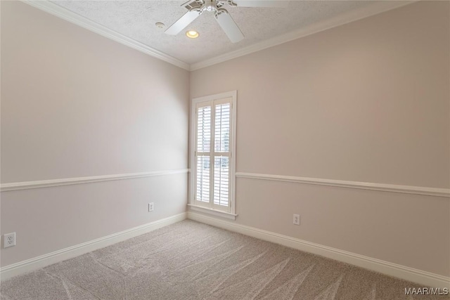 carpeted spare room with crown molding, a textured ceiling, baseboards, and ceiling fan