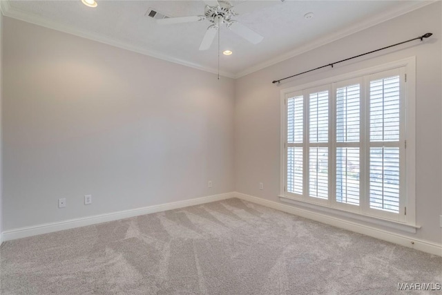 carpeted spare room with ceiling fan, recessed lighting, visible vents, baseboards, and crown molding