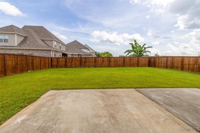 view of yard with a fenced backyard and a patio