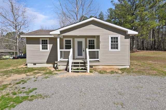 bungalow-style house featuring crawl space, a porch, and roof with shingles