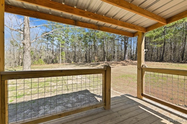 wooden terrace with a view of trees