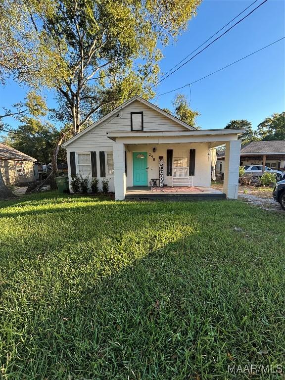 bungalow-style home featuring a porch and a front yard