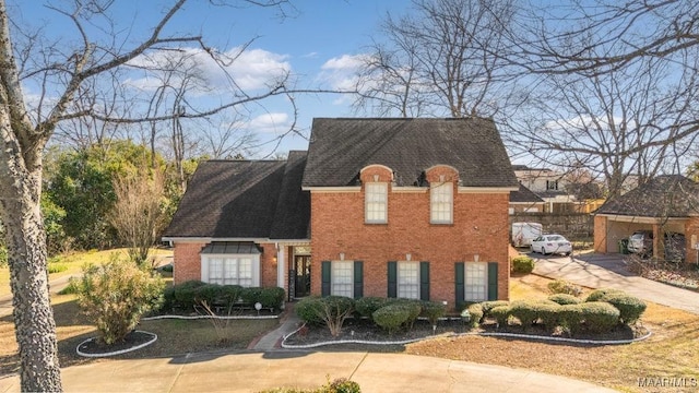 view of front of property featuring concrete driveway and brick siding