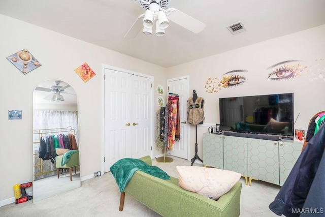 sitting room featuring baseboards, carpet, visible vents, and a ceiling fan