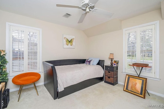 carpeted bedroom featuring baseboards, visible vents, vaulted ceiling, and a ceiling fan