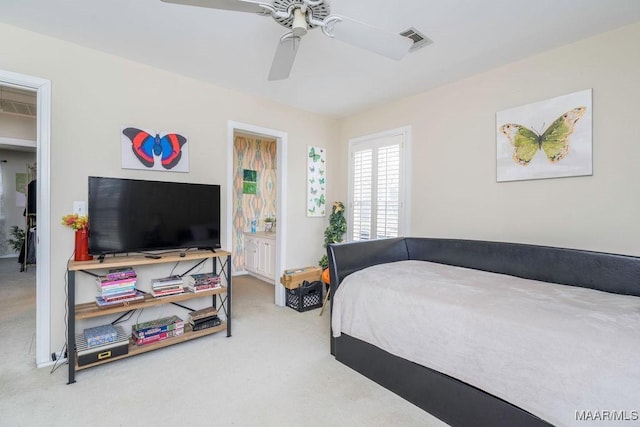 carpeted bedroom featuring a ceiling fan and visible vents