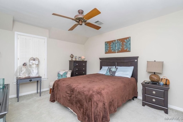 bedroom with baseboards, visible vents, light colored carpet, lofted ceiling, and ceiling fan