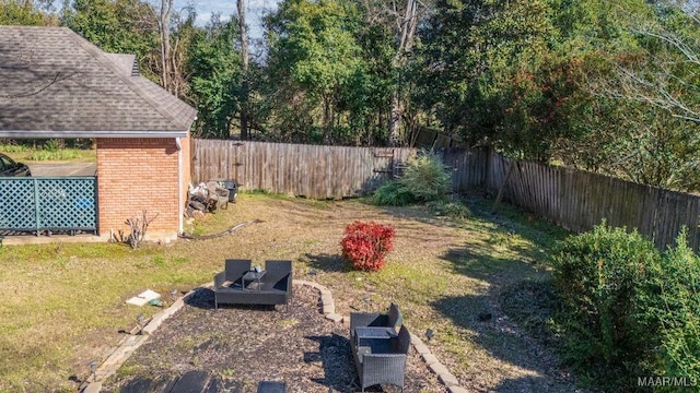 view of yard featuring an outdoor fire pit and a fenced backyard