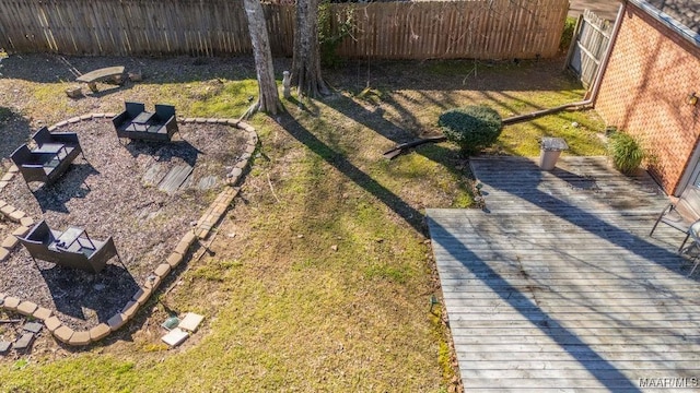 view of yard with a fenced backyard and a wooden deck