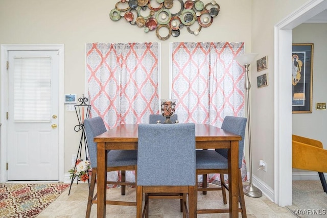 dining space featuring baseboards