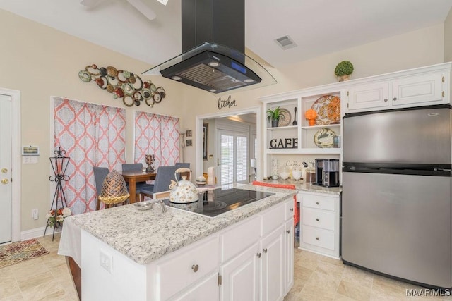 kitchen with open shelves, freestanding refrigerator, a kitchen island, island range hood, and black electric cooktop