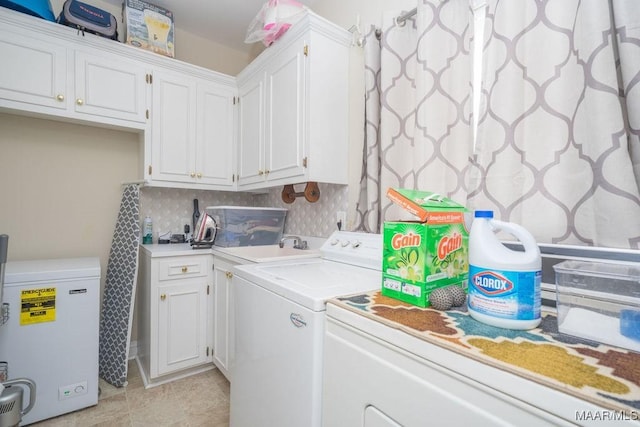 laundry area with light tile patterned floors, washing machine and clothes dryer, and cabinet space