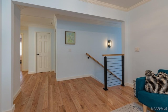 interior space with ornamental molding, baseboards, and wood finished floors