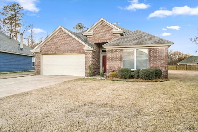 view of front facade with a garage, a front yard, concrete driveway, and brick siding