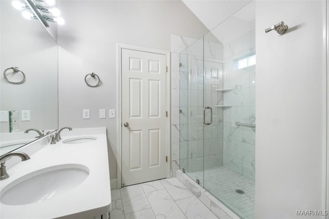 full bathroom with a stall shower, marble finish floor, and a sink