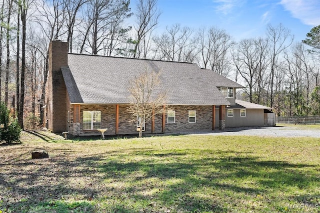 view of front of home with stone siding, a chimney, and a front yard