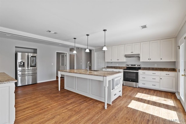 kitchen featuring white cabinets, visible vents, stainless steel appliances, and a sink