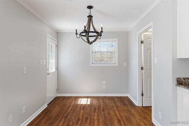 unfurnished dining area with a notable chandelier, baseboards, ornamental molding, and wood finished floors