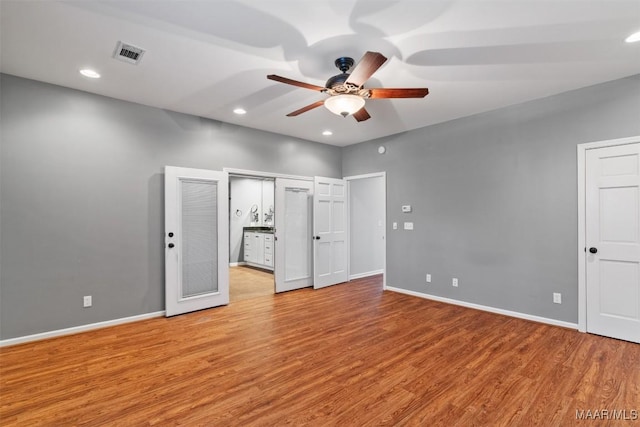 unfurnished bedroom with light wood-style floors, visible vents, and baseboards