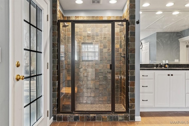 bathroom featuring visible vents, a stall shower, vanity, and recessed lighting