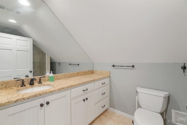 bathroom featuring toilet, vanity, visible vents, vaulted ceiling, and baseboards