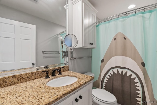 bathroom featuring vanity and toilet