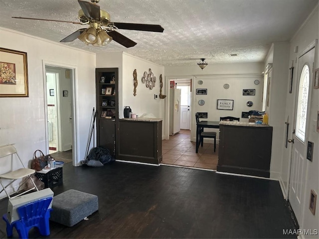 kitchen with a textured ceiling, white fridge with ice dispenser, wood finished floors, and a ceiling fan