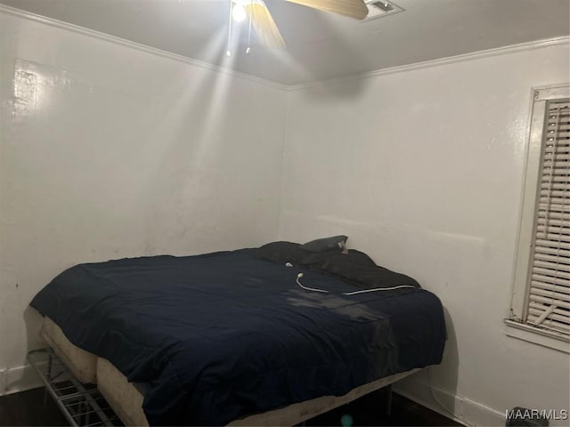 bedroom featuring a ceiling fan and crown molding