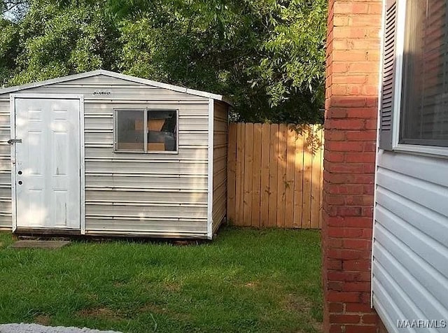 view of shed featuring fence