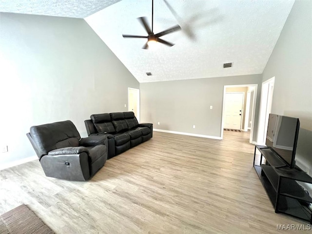 living room with visible vents, light wood-style floors, a textured ceiling, high vaulted ceiling, and baseboards