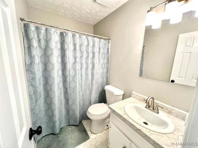 bathroom with toilet, a shower with curtain, tile patterned floors, a textured ceiling, and vanity