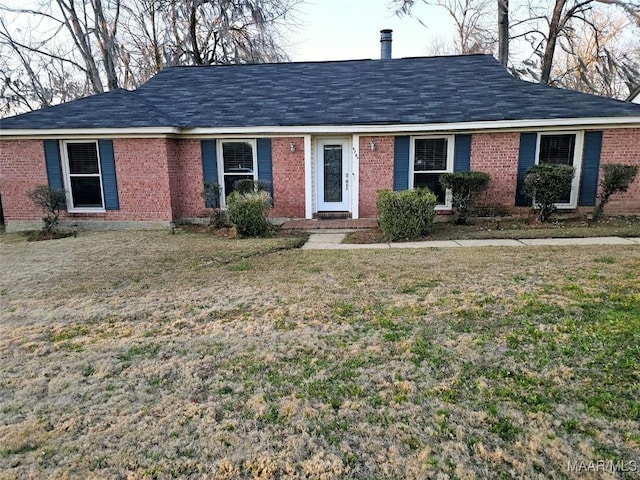 ranch-style house with brick siding and a front yard