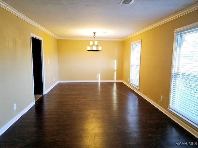 unfurnished room featuring an inviting chandelier, baseboards, ornamental molding, and dark wood finished floors