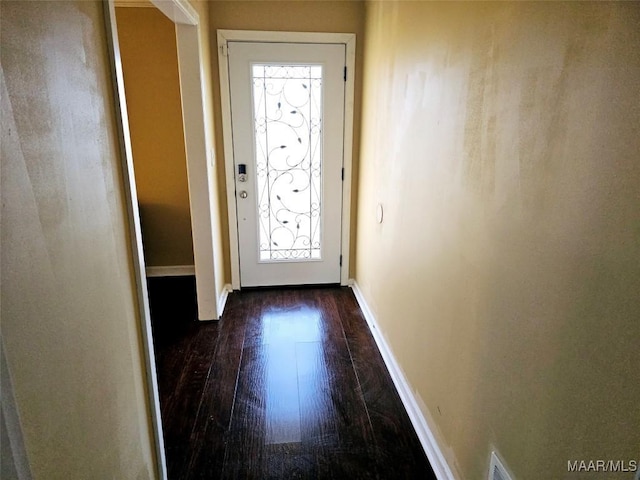 entryway with dark wood-style floors and baseboards