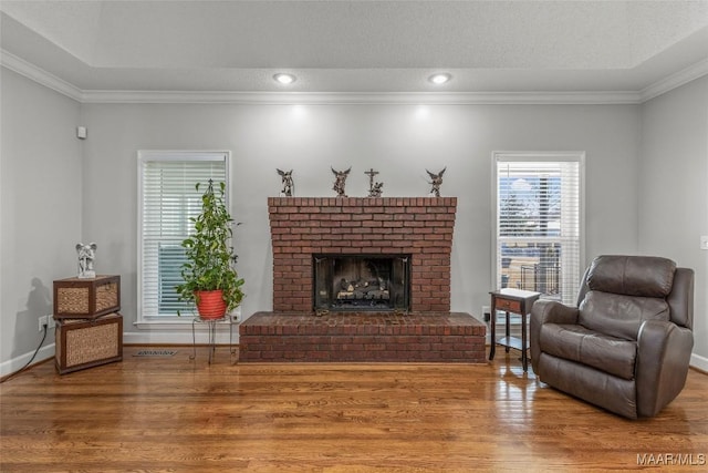 9524 County Road 42nd Rd, Jemison, AL 35085 - living area with crown molding, a brick fireplace, wood finished floors, and visible vents