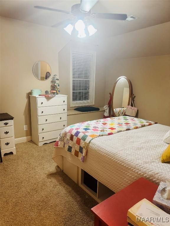 bedroom with carpet floors, visible vents, and ceiling fan