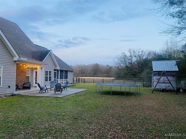 view of yard with a fenced backyard, a trampoline, and a patio