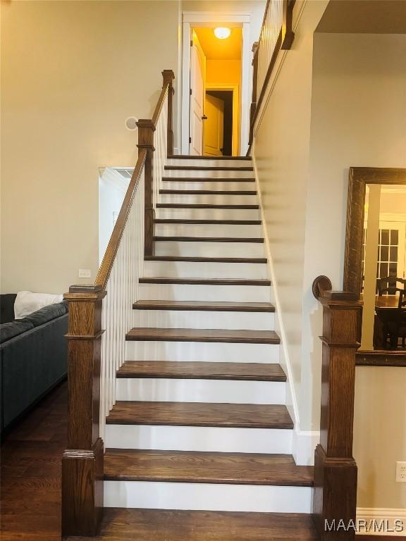 stairway with wood finished floors