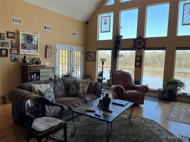 living area featuring wood finished floors, visible vents, and a healthy amount of sunlight